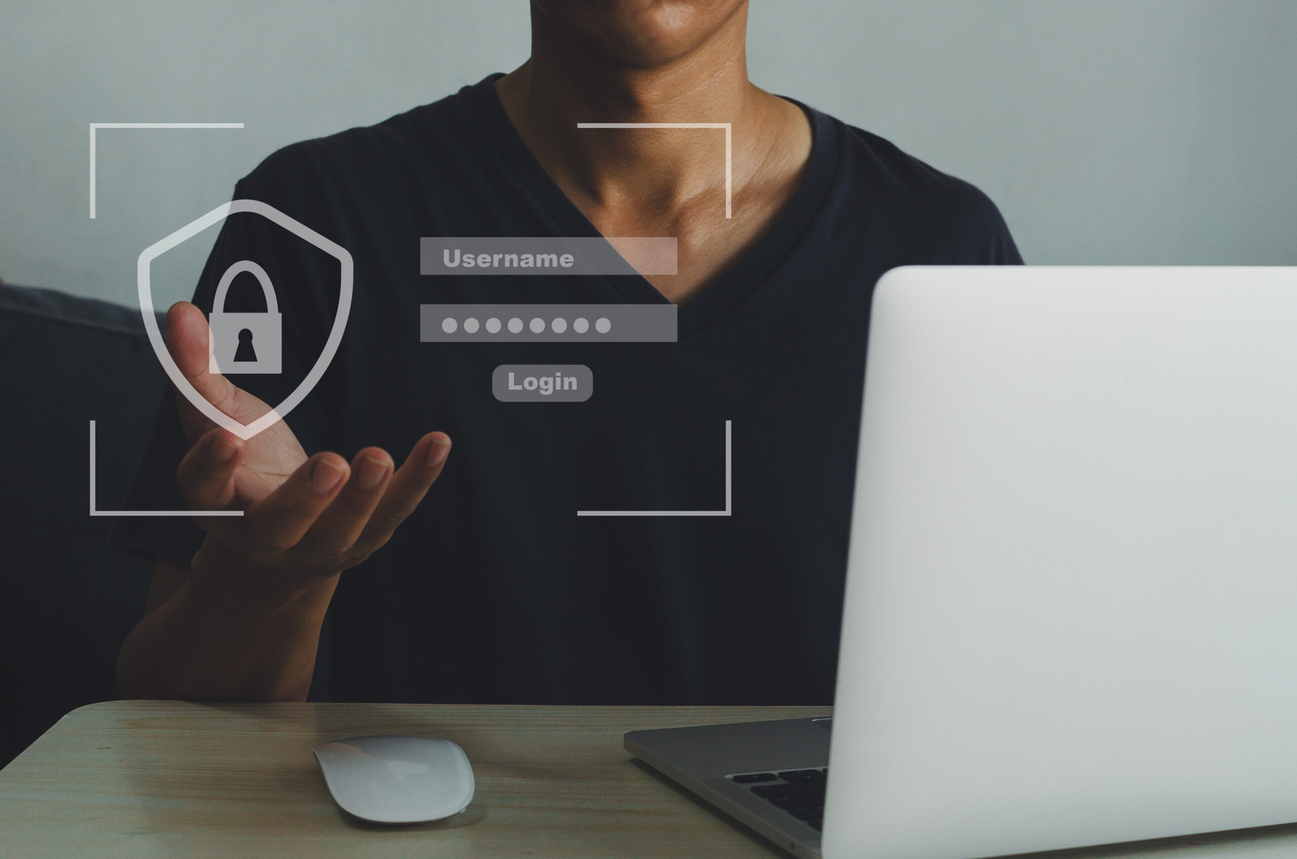 Man using computer laptop login page username and password on a virtual screen.  Business technology concept.