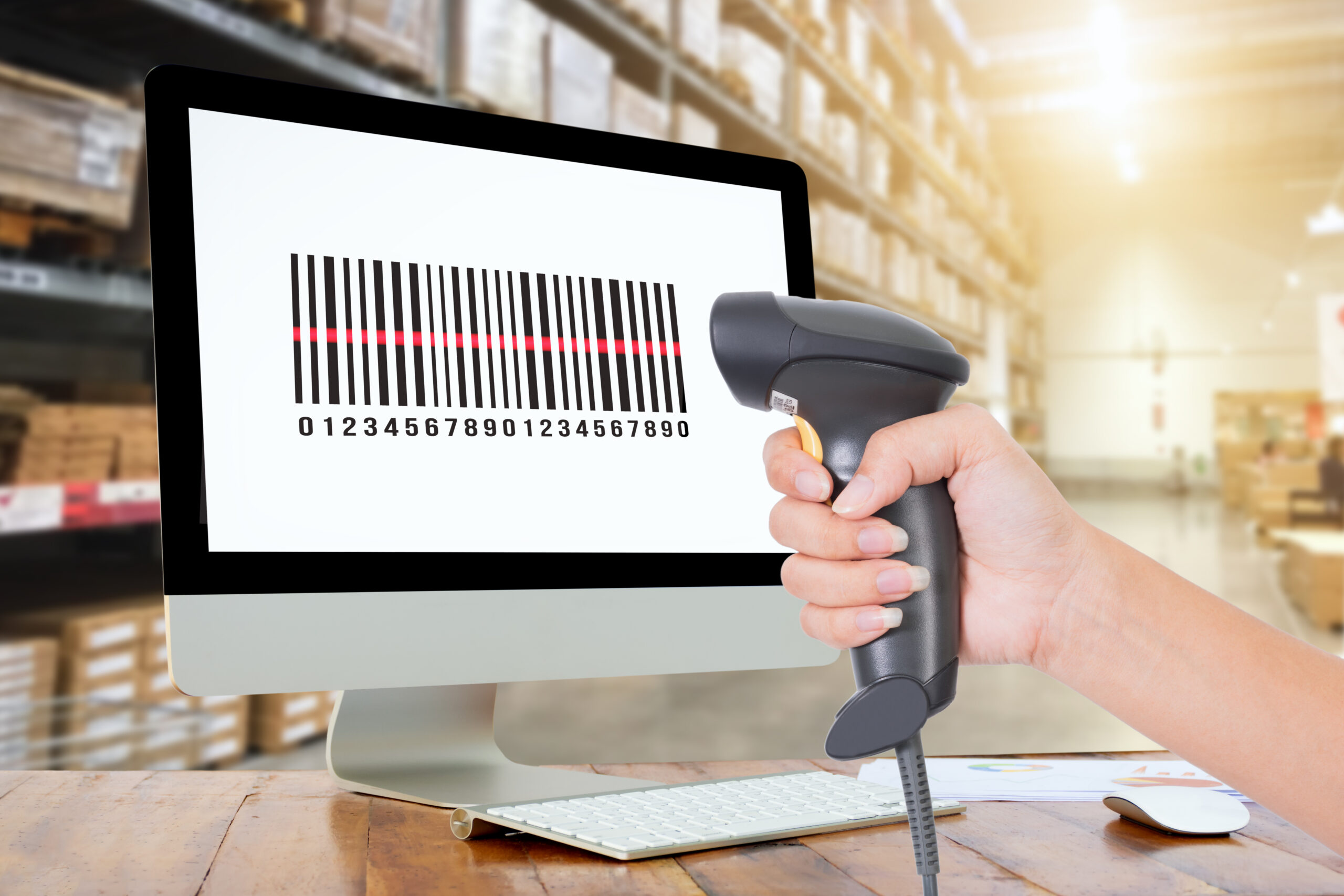 Woman scanning barcode from a label in modern warehouse